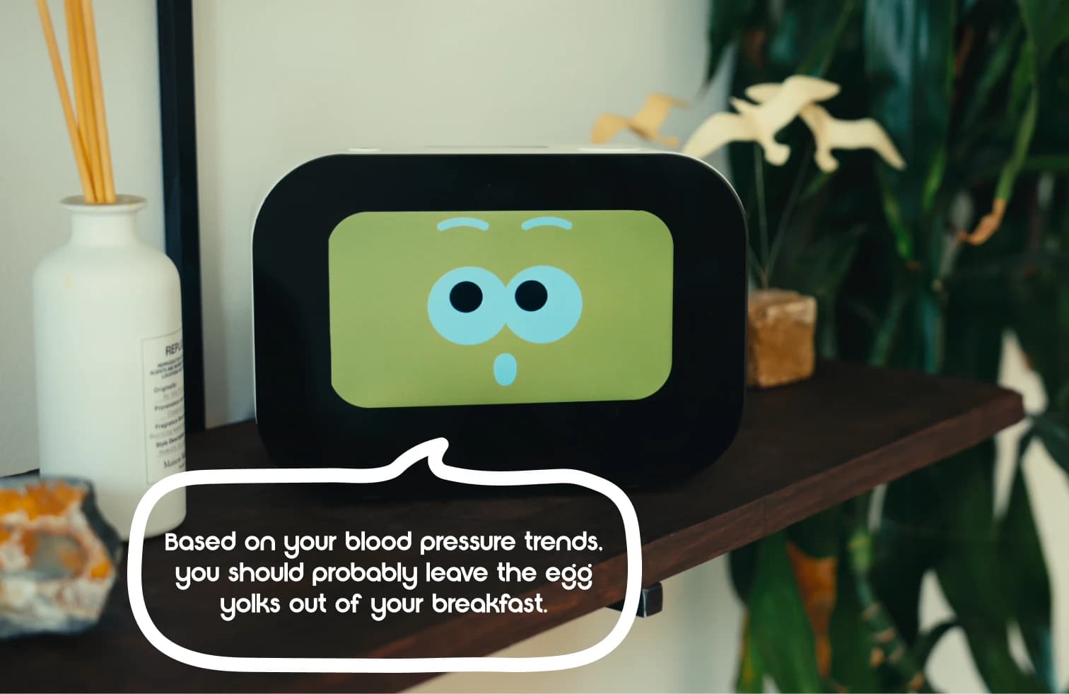Rhem, the AI health and wellness robot, displaying a wellness trend on its face.